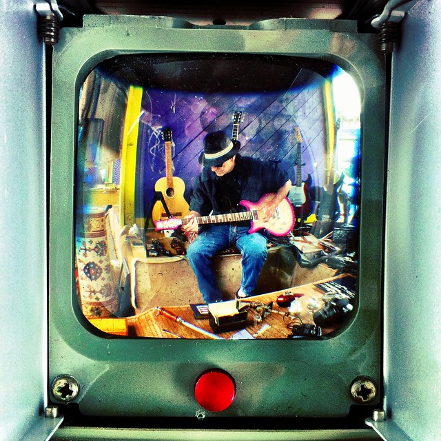 Shooting through the viewfinder of an old Anscoflex camera. I just bought it from the guy playing guitar.