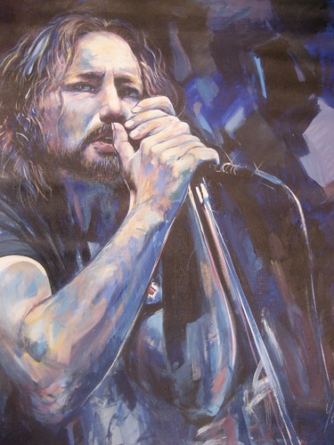 Singer holding a microphone with another face behind