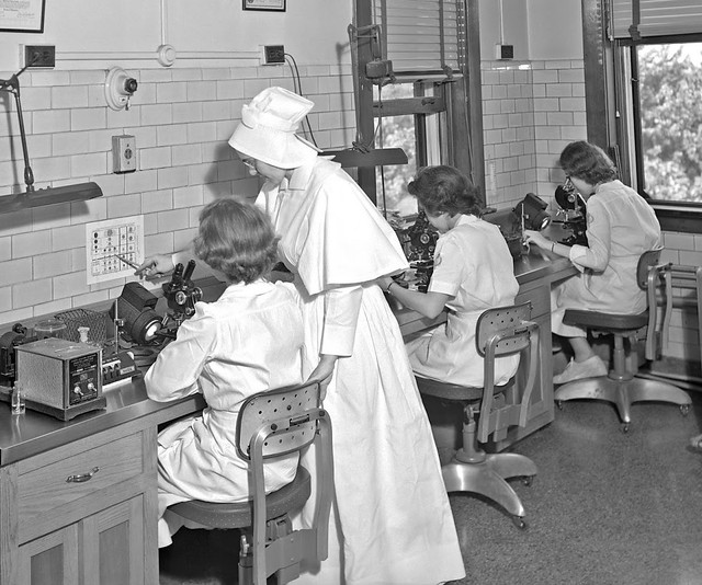 Sister of Charity of Nazareth at St. Joseph's Hospital, laboratory, nun standing next to three women operating microscopes, 1949