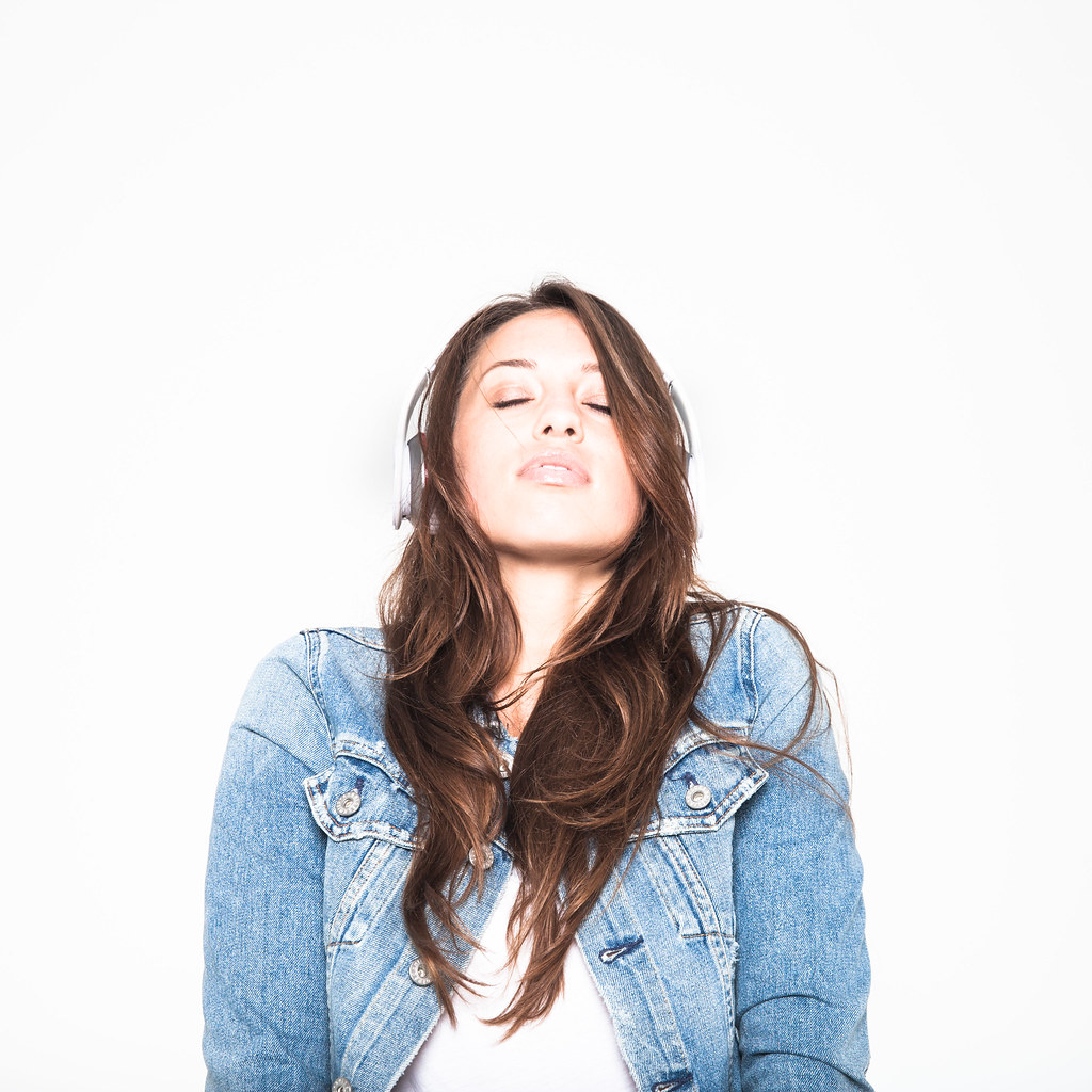 Adult comfortably listening to focus soundscapes with over-ear stereo headphones
