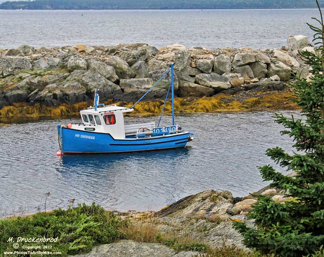 A typically colorful lobster boat anchored at Blue Rocks Nova Scotia