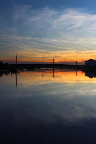 bridge blue sunset sky orange reflection portugal water yellow clouds mirror boat village setúbal