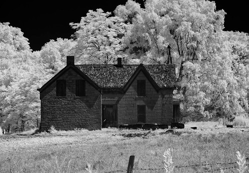 trees fence shadows infrared brokenroof pasture unpaintedwood wires oxidation tires weathered boardedupwindows