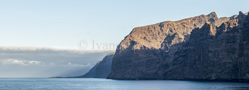 mountain hill slope cliff sky clouds horizon rock island sun sunrise blue sea ocean water wave surf surge tide foam coast coastline landscape perspective ascent descent shadow mountainrange mountainpeak nature travel tourism spain canaryislands tenerife