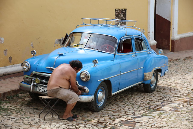 A man fixing his beautiful old car:)