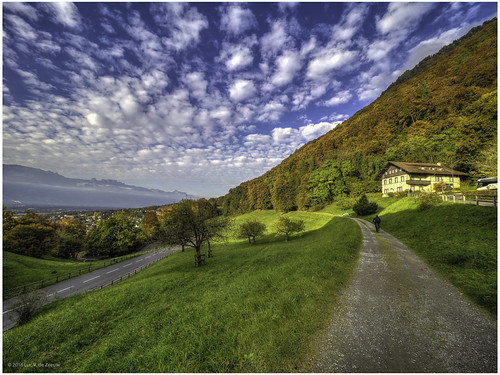 Landscape near Castle Vaduz by Luc V. de Zeeuw, Vaduz, Liechtensteinbicyclist clouds house meadow mountain sunset trees vaduz liechtenstein