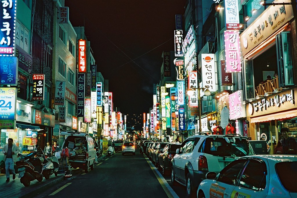 ourbedtimedreams:   	night street - busan by Shoji Kawabata. a.k.a. strange_ojisan    	Via Flickr: 	FUJI FILM KLASSE S + Lomography CN 800 35mm   