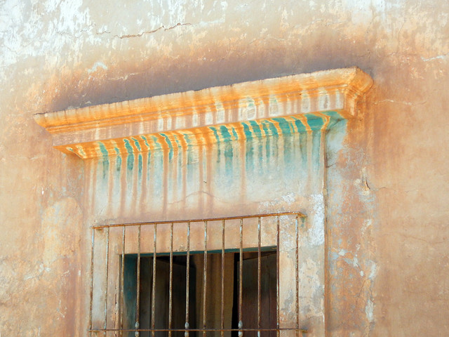 A coloured wall and barred window in Mascota, a 'Pueblo Magico' on the Sierra Madres Occidental on the Pacific coast of Mexico