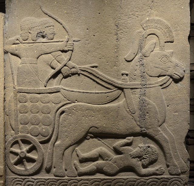 Relief orthostat (stone slab at base of wall) of a Hittite war chariot, a naked enemy with an arrow in his hip is lying face down under the horse's feet, from Carchemish (Turkey), Basalt; Late Hittite period, 9-7th cent BC, Museum of Anatolian Civilizatio