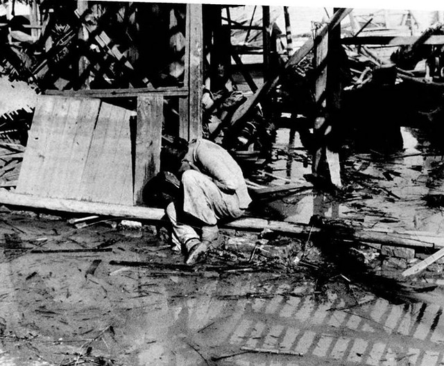 #A Chinese woman weeps in the rubble following a Japanese air raid in Hankou. Hankou was captured by the Japanese invaders in 1938 after the Battle of Wuhan. Hankou, Wuhan, Hubei, Republic of China. September 1938. Image taken by Robert Capa. [1162 x 960]