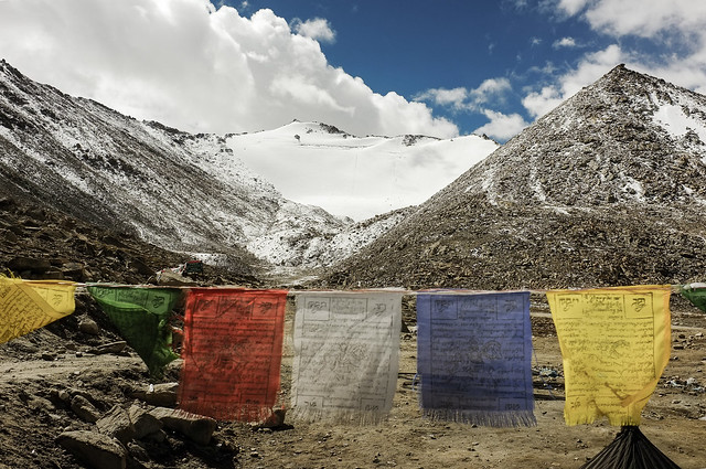 Prayer flags against snow capped mountain.. Chang La, Ladakh