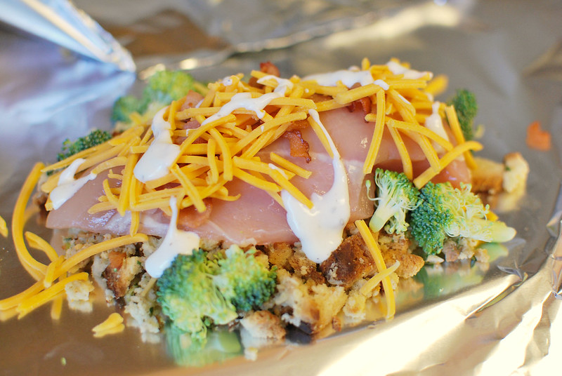 Cheesy Chicken Hobo Packets - stuffing, chicken, broccoli, bacon, and cheese all layered and cooked in foil packets. They can be cooked in the oven or on the grill. Easiest dinner ever!
