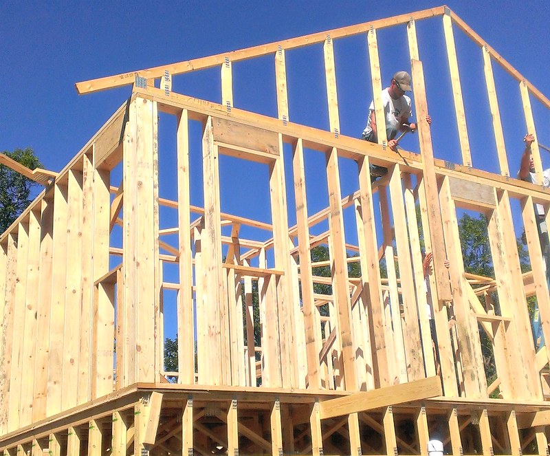 A man working on a house frame