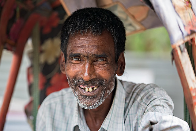 Portrait of a smiling Rikshaw driver in Guwahati, India.