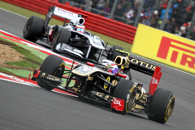 Vitaly Petrov - Renault R31 exits Becketts  followed by Rubens Barrichello - Williams FW33 at the 2011 British GP, Silverstone