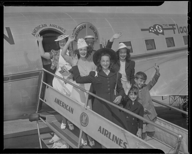 Group waving from American Airlines plane
