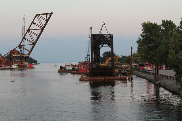 The middle (and final) span of the CN (former CN&W) 1899 swing bridge was temporarily placed next to Pioneer Drive before being dismantled. Its successor rises behind it.