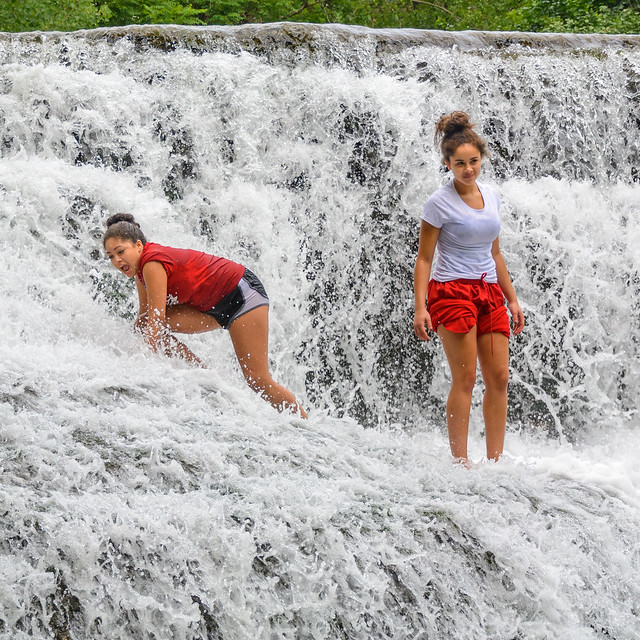 Young Women Enjoy the Splashing Water at Thistlethwaite Falls