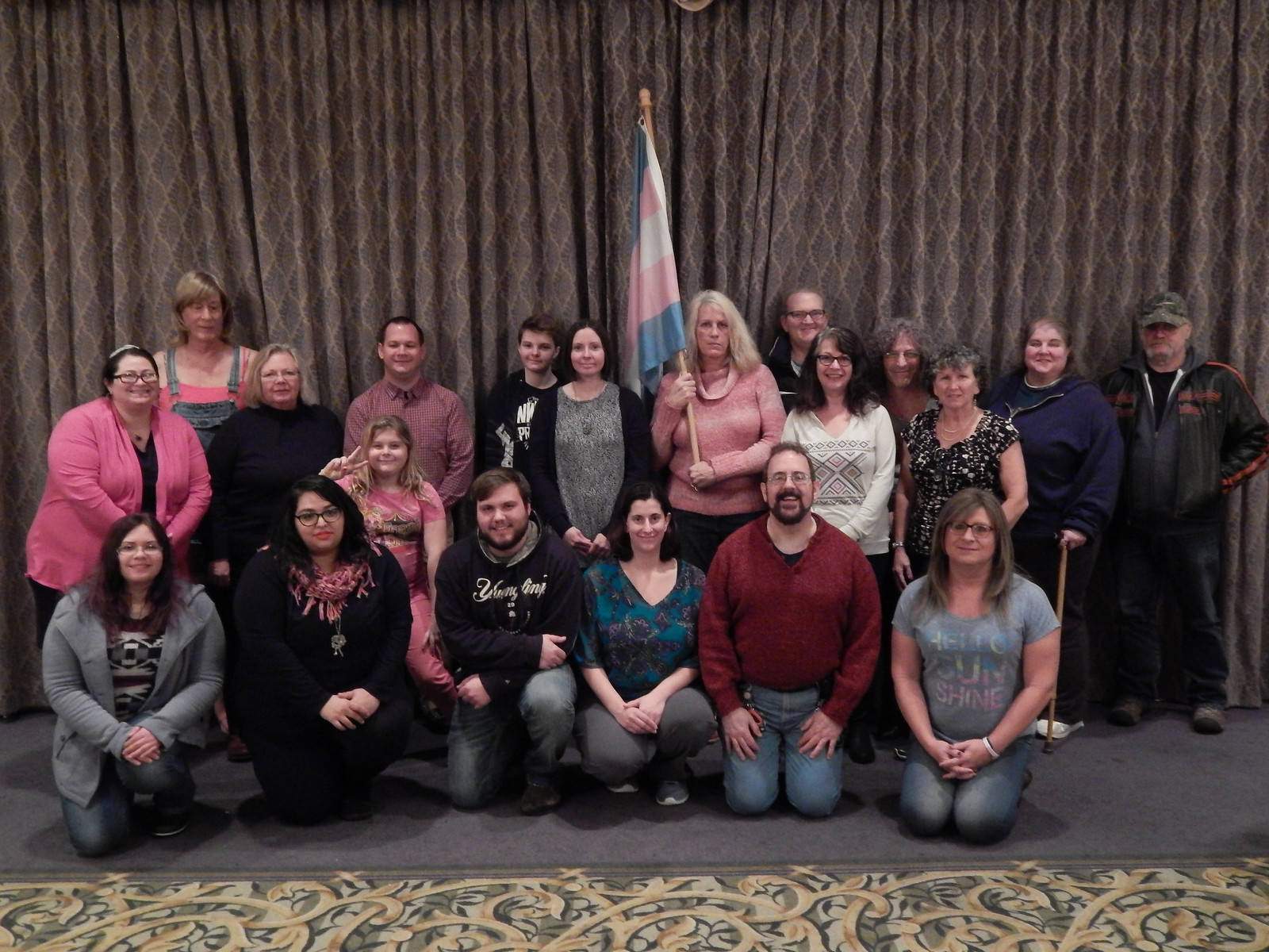 Group photo with Trans Pride flag