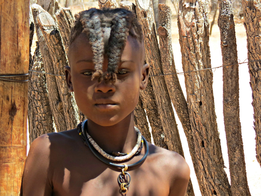 A young Himba girl wearing the pre-puberty hair style of t… | Flickr