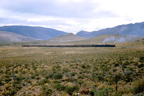 R4300.  Mosel Bay Express climbing the Lootsberg Pass. 1st September,1972. by Ron Fisher, R4300.  A pair of 19B class 4-8-2s head the ‘Mossel Bay Express’ northbound from Graaff Reinet and t