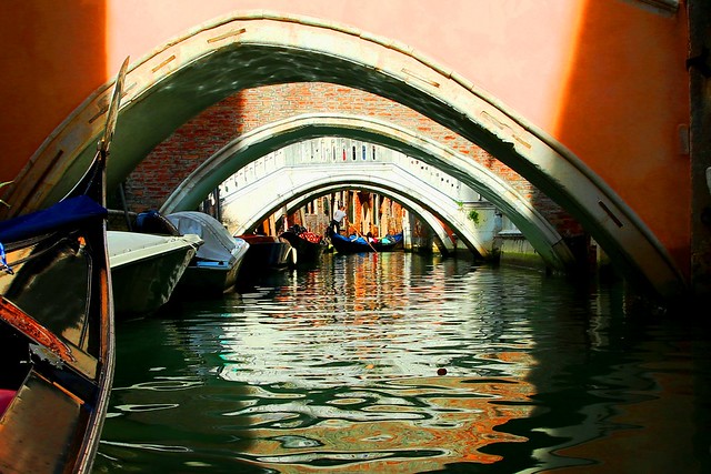 Gondola Through a Series of Venice Bridges