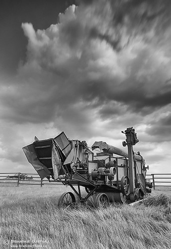 Abandoned threshing machine and storm clouds, Saskatchewan by Branimir Gjetvaj, Treshers were used for the separation of grain from stalks and husks. Old Man on His Back Prairie an