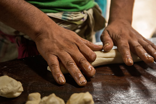 Hands of a man at a market in Swarupkathi, Bangladesh.