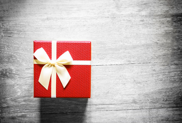 Red christmas gift box on wooden table