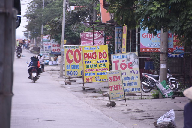 A line of cafes on the way advertising Pho