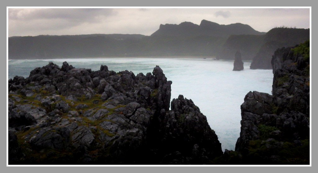 TYPHOON WEATHER AT HEDO POINT -- Looking South Through a Karst Fissure Over Uza Bay to the Karst Peaks