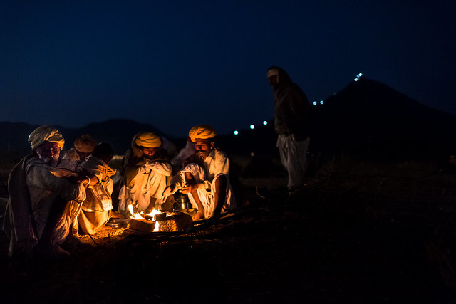 Marwari Camel Trader around the fire at night in the Pushkar Camel Fair