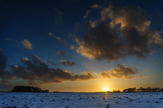 Sun sets in a Snowy Landscape