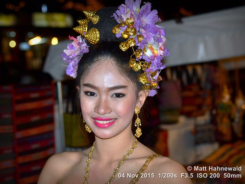 night dancer beautiful travel tourism blue gold beautifuleyes ethnic posing makeup cultural character female gorgeous lips portrait nightmarket smiling beauty girl primelens lipstick teeth street eyes asia flash matthahnewaldphotography face facingtheworld chiangrai wreath hairjewelry horizontal jewelry nikond3100 outdoor thai flower 50mm expression northern thailand shoulders nikkorafs50mmf18g threequarterview colour colourful person closeup consensual lookingatcamera