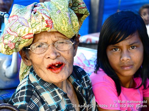 arecanut paan chewingtobacco stainedteeth travel smiling ethnic street portrait cultural character female market posing betelnut eyes face facingtheworld batak indonesia toba woman nikond3100 outdoor sumatra diversity betelstainedteeth lifestyle nikkorafs50mmf18g person closeup fullfaceview matthahnewald headshot colorcolour lookingatviewer colorfulcolourful