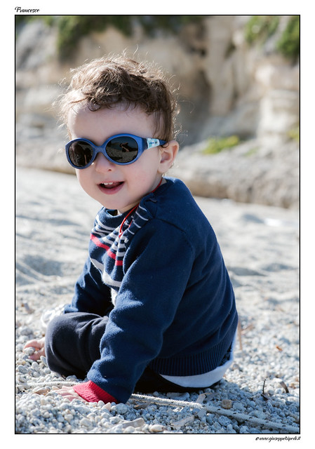 Portrait of a ( glamour, fashion, trendy and cool ) child on the beach