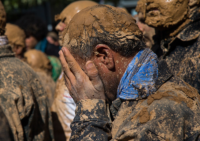 iranian shiite muslim man covered in mud crying during ashura day, Kurdistan Province, Bijar, Iran