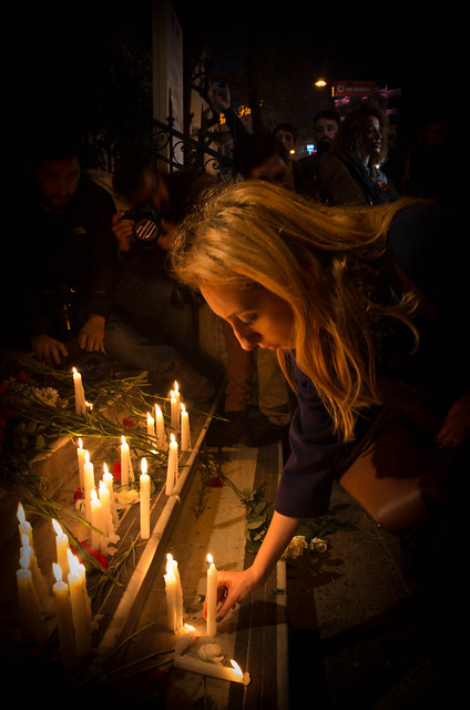 Women lighting candle for Paris victims, in Istanbul, Turkey.