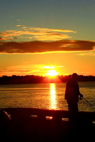 ocean morning orange sun water sunrise person fishing solitude bright peaceful wharf