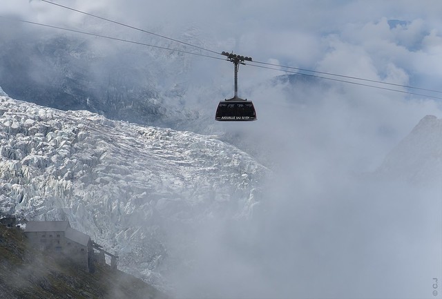 Air trip, the Aiguille du Midi gondola hovering over the icefall and the terminal station from the former cable car