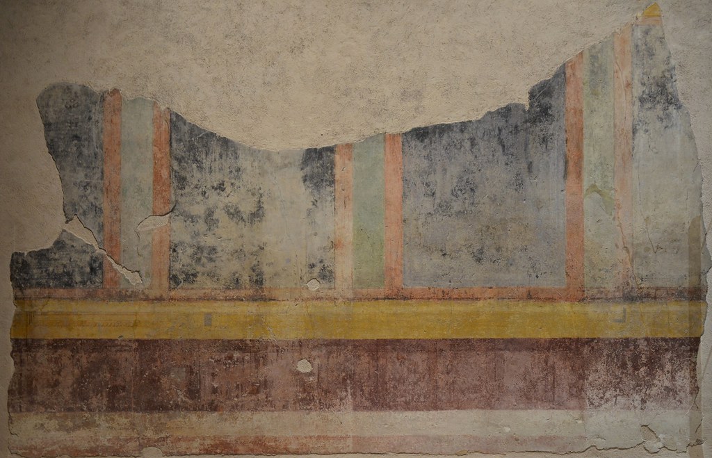 Wall painting fragment which decorated the atrium of the House of Livia alterning wide black and narrow green panels framed in red and bordered above and below in yellow bands, House of Livia, Palatine Hill, Rome