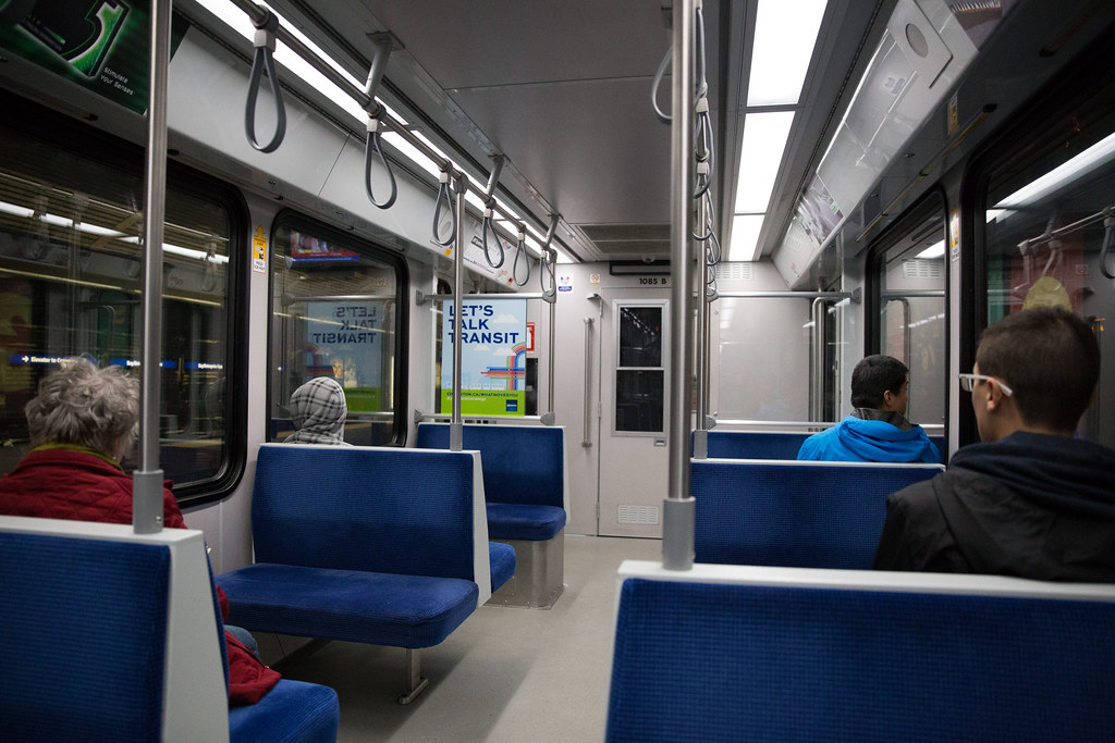 Passengers sitting inside an Edmonton LRT car