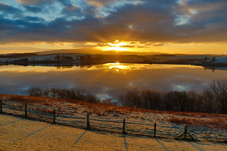 Snowy lake with beautiful sunrise and reflection in HDR