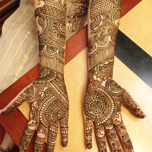 Bridal Mehndi Designs - This is a Punjabi mehndi design. When brides wear  red nail polish colors with henna on hands, it just enhances the henna  color and the overall look. The