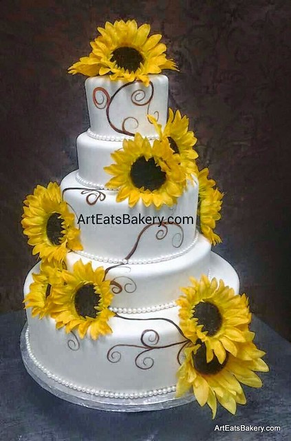 Four tier custom white fondant modern wedding cake with hand painted brown vines and silk sunflowers