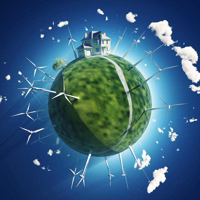 house and wind turbine on green planet