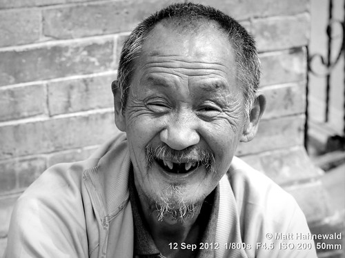 portrait travel smiling ethnic posing primelens cultural character male mouth nose temple beard laughing wrinkles greyscale street eyes matthahnewaldphotography face facingtheworld china chinese blackandwhite head nikond3100 xian 50mm teeth livedinface expression highangle headshot lifestyle nikkorafs50mmf18g fullfaceview emotional closeup consensual monochrome lookingatcamera