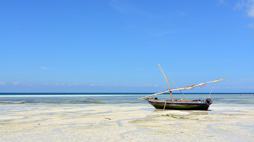 africa tanzania zanzibar summer vacation kizimkazi indianocean ocean sand whitesand endlessblue beach blue boat sailboat dhow