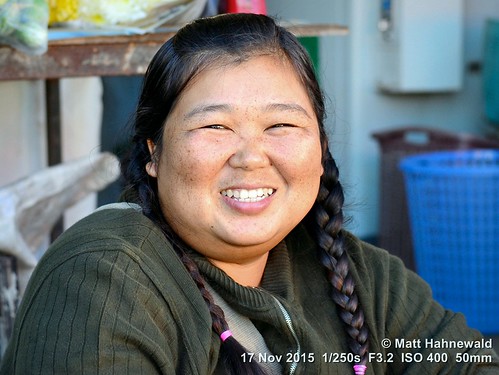 portrait smiling travel tourism market obese ethnic primelens braids woman female cultural character posing consent emotion adult authentic closeup street eyes asia matthahnewaldphotography face facingtheworld chiangdao horizontal head nikond3100 outdoor thailand thai 50mm expression northern headshot nikkorafs50mmf18g fullfaceview 4x3ratio 1200x900pixels resized lookingatcamera colour colourful person