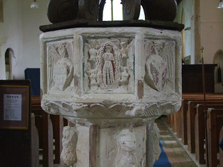 font (L-R): angel holding a shield with the arms of the Diocese of Ely, Assumption of the Blessed Virgin, angel holding a shield with the arms of the Archdiocese of Canterbury